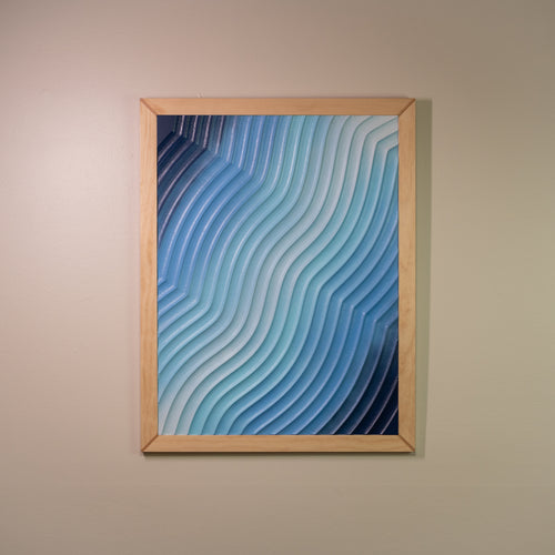 Framed 3D carved wall art in blue gradient tones, titled "Eventide Loop", shown from the front on a neutral wall.