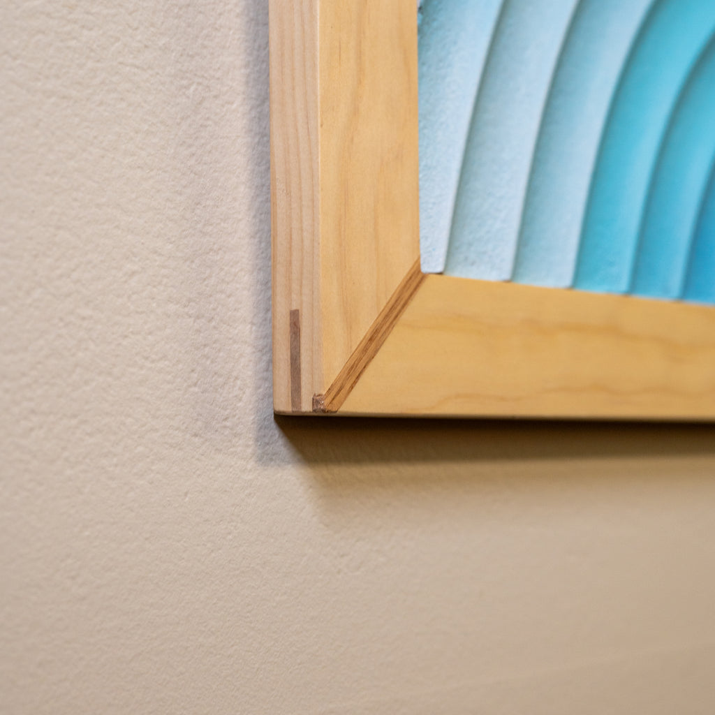 Detailed close-up of the wooden frame corner joint on "Eventide Loop" wall art.