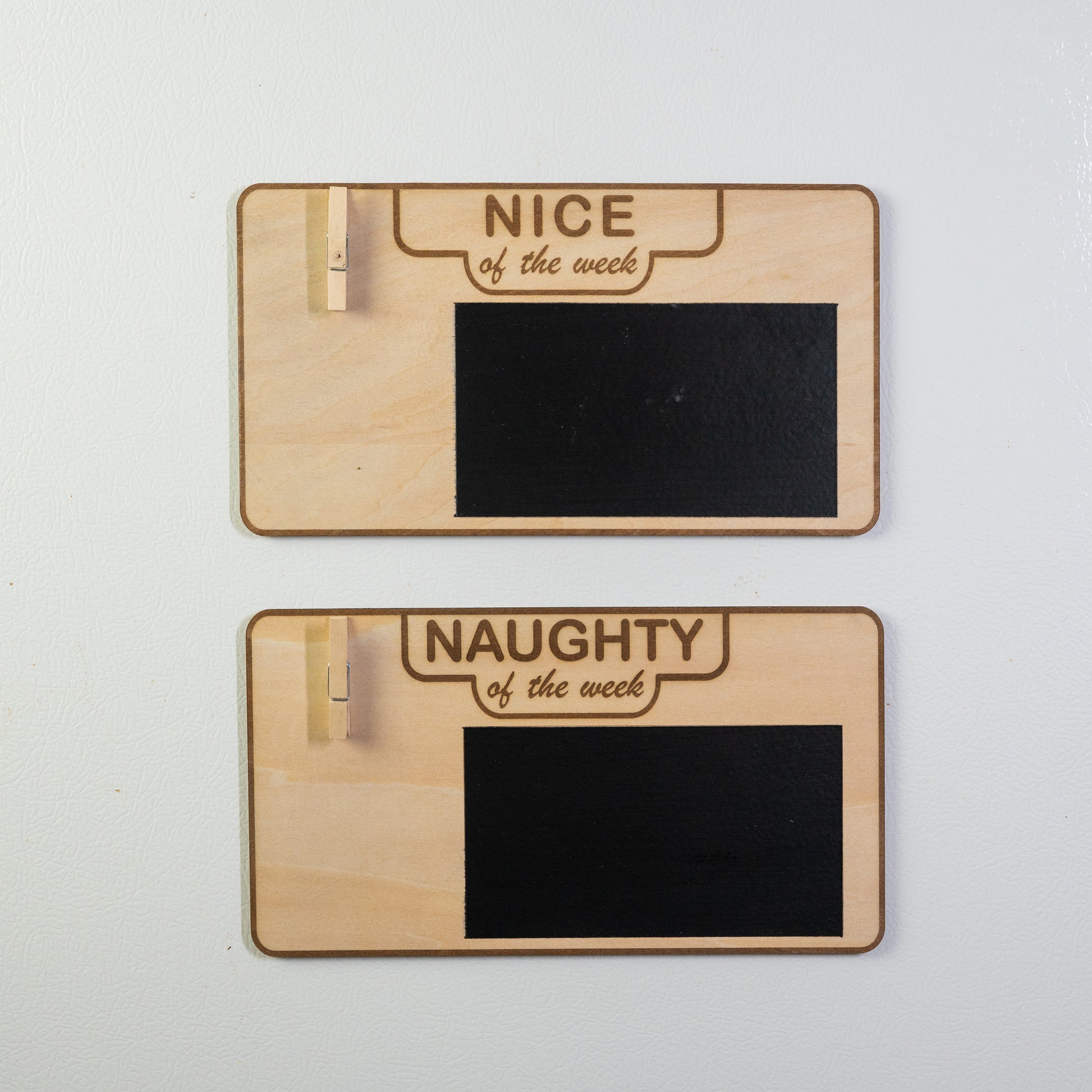 Blank versions of "Nice of the Week" and "Naughty of the Week" signs on fridge, ready for personalization.