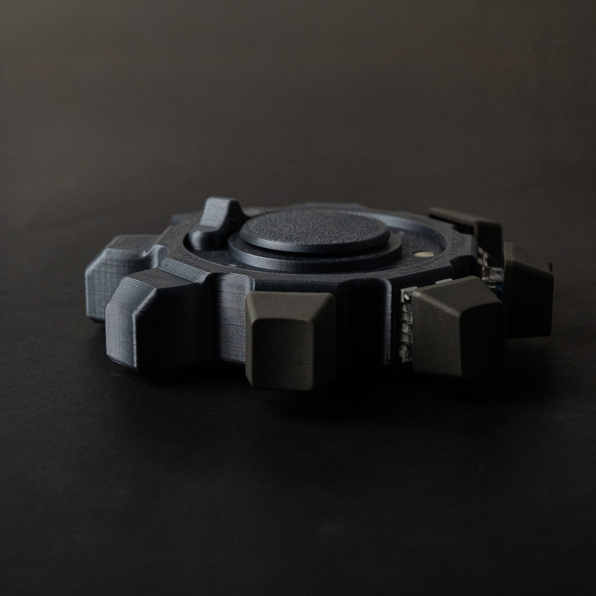 Side profile of industrial gear fidget spinner showing thickness and click module design.