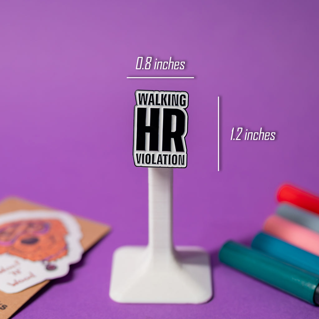 Close-up of Walking HR Violation enamel pin on clear plastic stand with size reference visible.