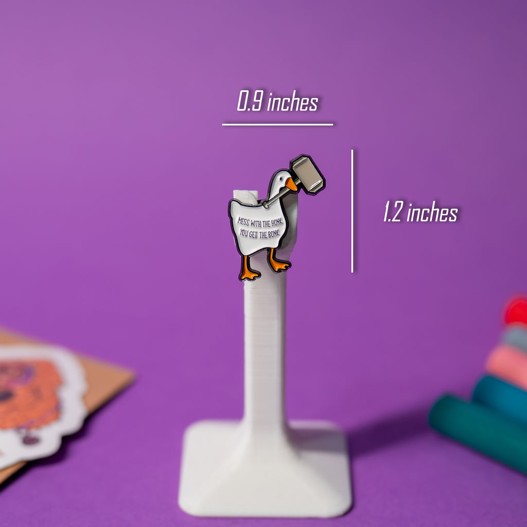 Hammer Goose enamel pin with size reference, part of Untitled Goose pin series.