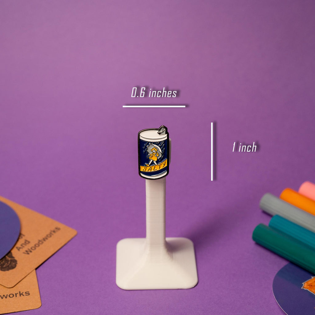 Close-up of Salty enamel pin showcasing bright colors and a playful twist on a classic design.