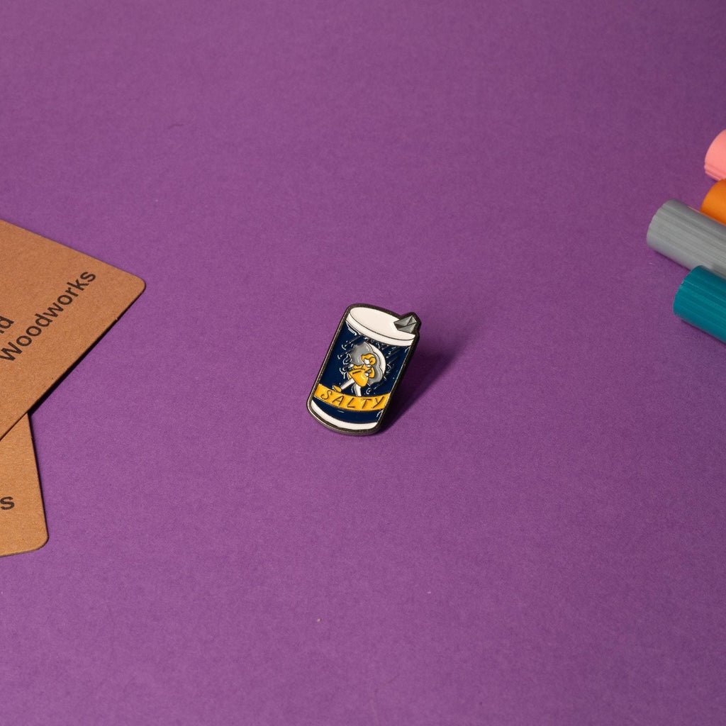 Enamel pin inspired by the Morton Salt package design with the bold text Salty perfect for humor lovers.