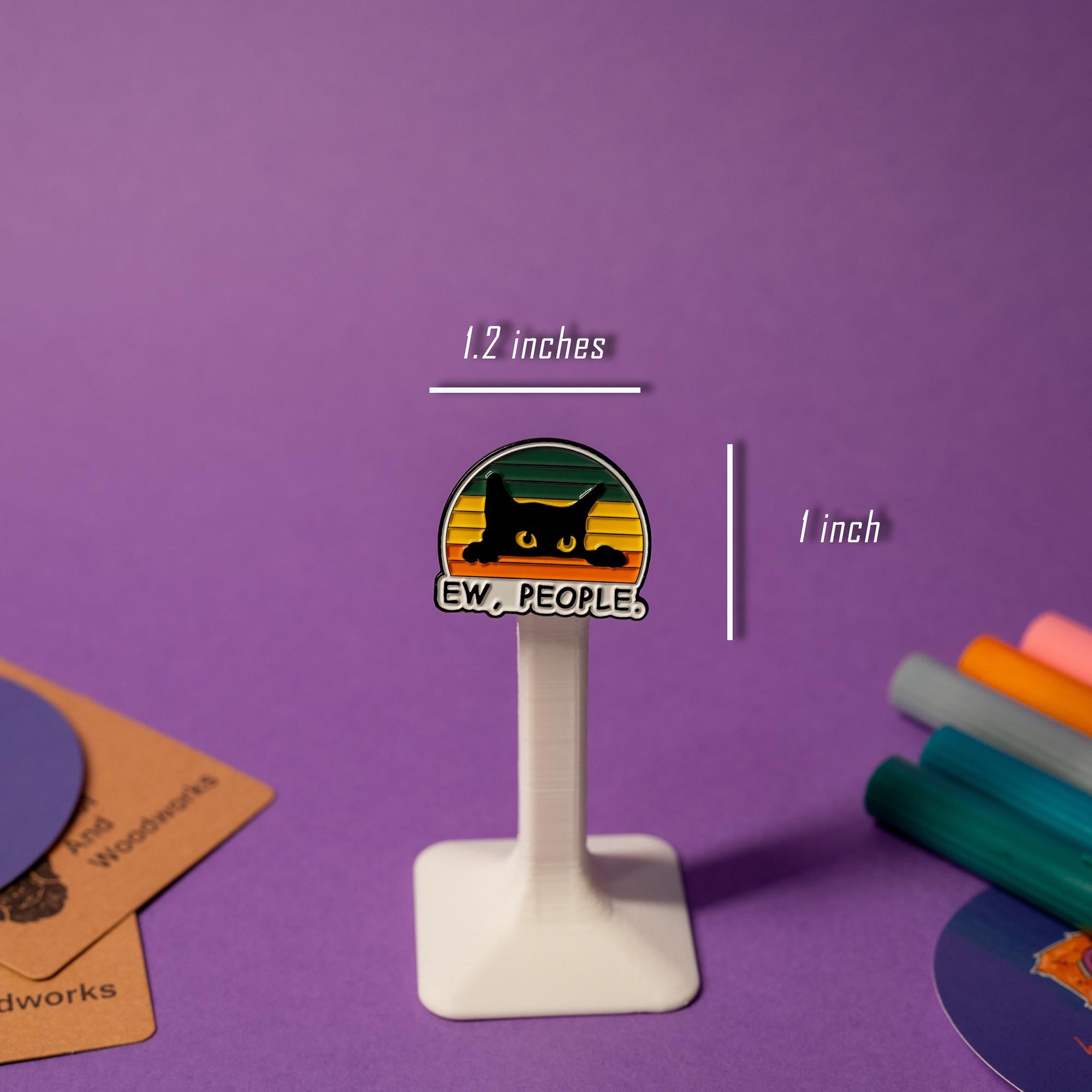Black cat enamel pin on a stand with the cheeky slogan Ew, People ideal for cat lovers.