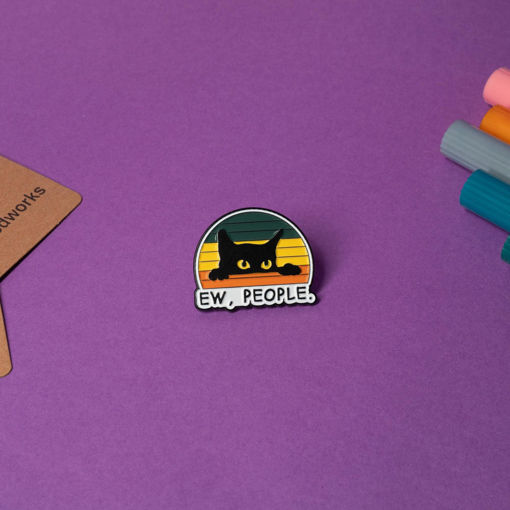Black and white enamel pin featuring a sassy black cat with the text Ew, People.