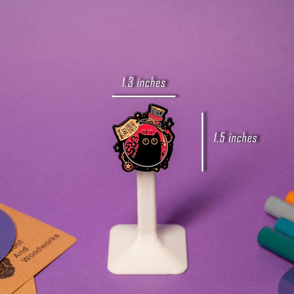 Close-up of enamel pin showcasing a black cat inside a magical flask with Do It and Don’t Open – Evil Inside warnings.