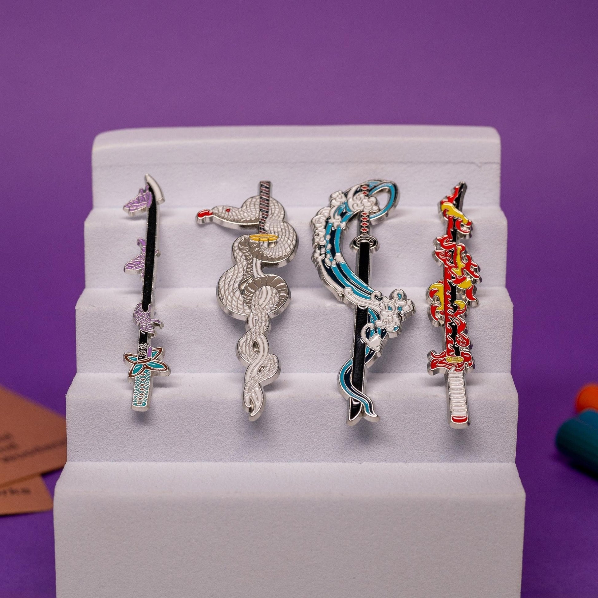Set of Demon Slayer enamel pins featuring swords with Water, Flame, Serpent, and Insect Breathing styles.