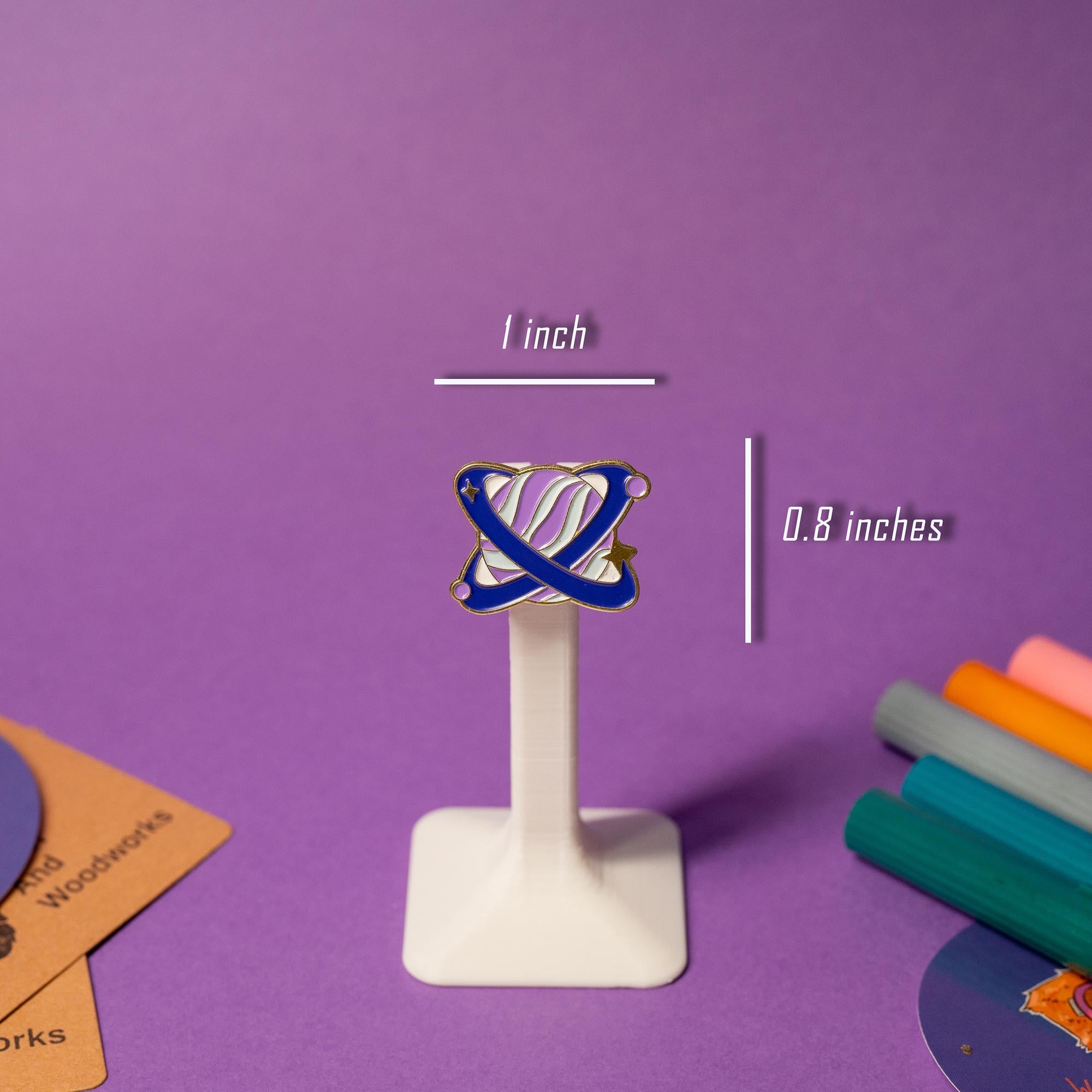 Close-up of a single planet enamel pin from the fantasy galaxy-inspired set, showcasing vibrant colors.