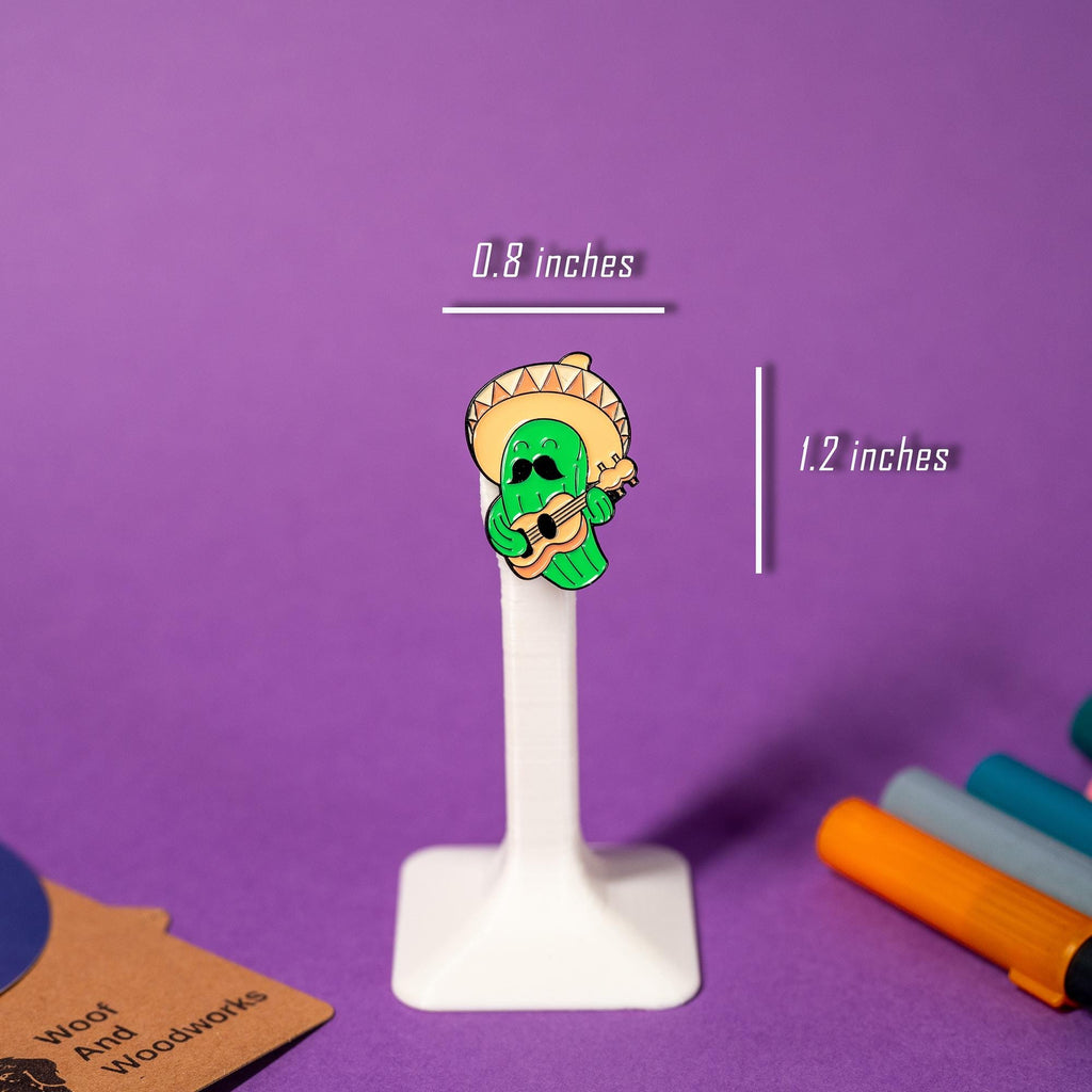 Cactus enamel pin wearing a sombrero, playing a guitar, and rocking a moustache, perfect for fun vibes.