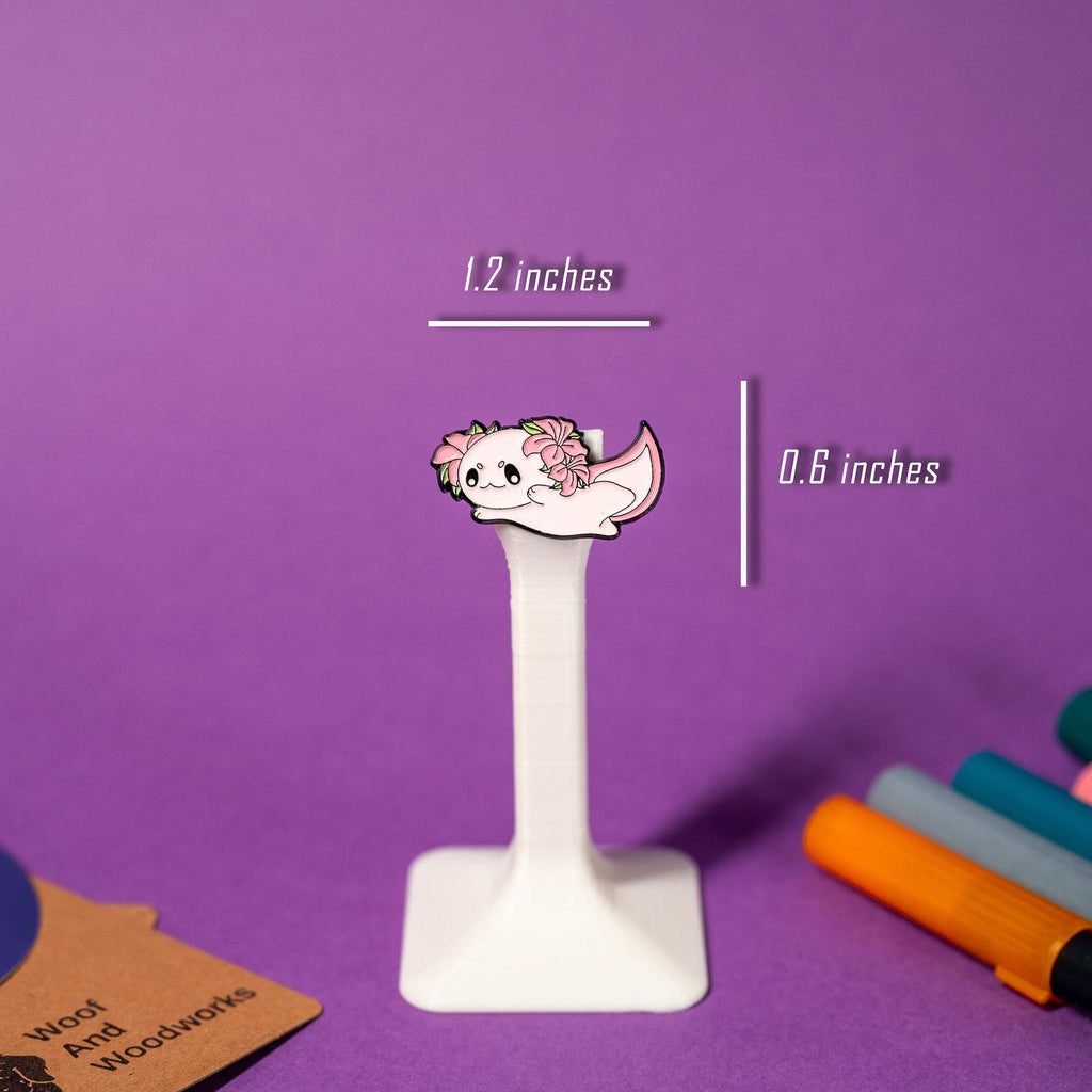 Kawaii-style axolotl enamel pin with a cheerful smile and vibrant pink gills.