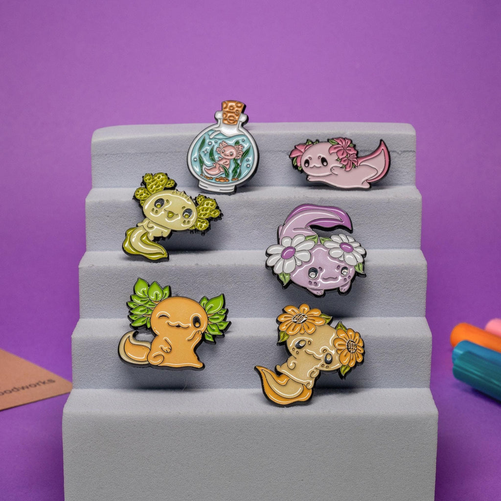 Set of 6 kawaii axolotl enamel pins featuring adorable designs inspired by axolotls and salamanders.