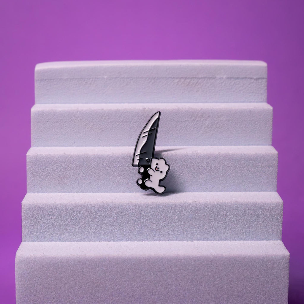 Knife Cat enamel pin showcasing a quirky black-and-white cat design with a knife, ideal for adding a touch of humor to any collection.