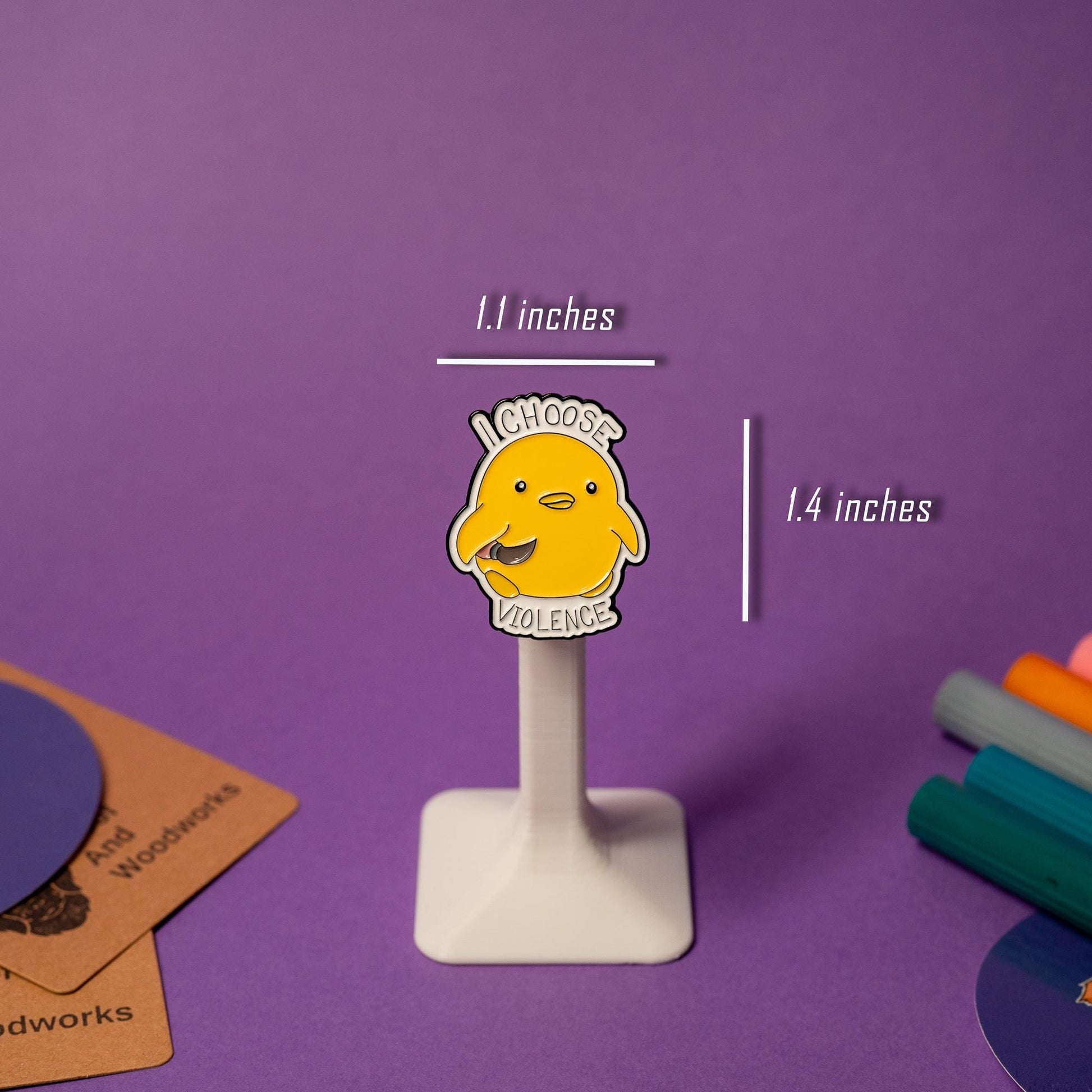 Enamel pin featuring a duck holding a knife with the humorous text I Choose Violence.