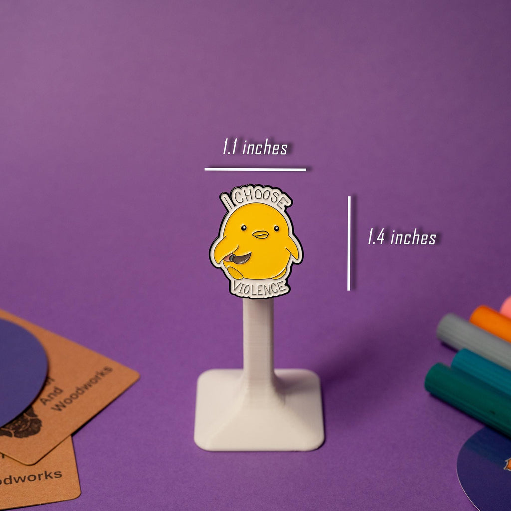 Enamel pin featuring a duck holding a knife with the humorous text I Choose Violence.