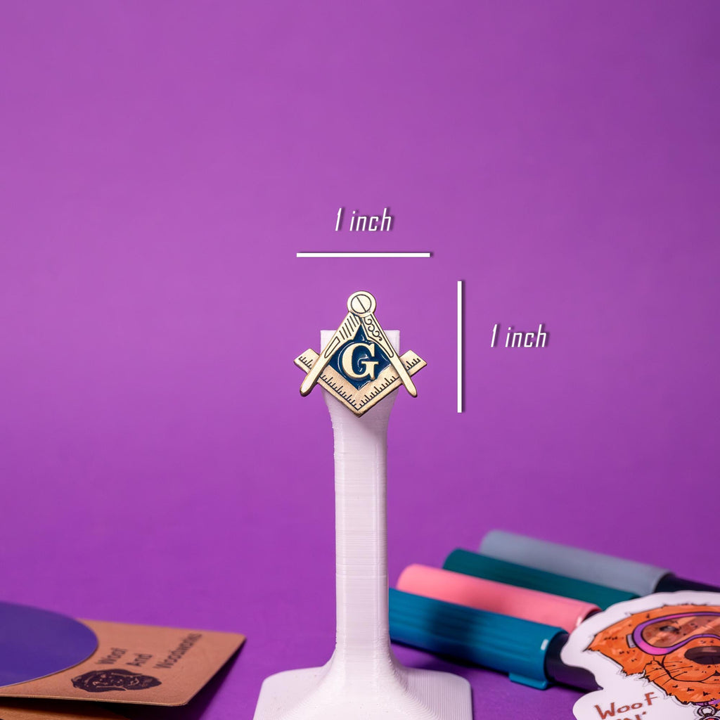 Close-up of the Freemason enamel pin, highlighting the intricate details of the Square & Compass and the prominent G.