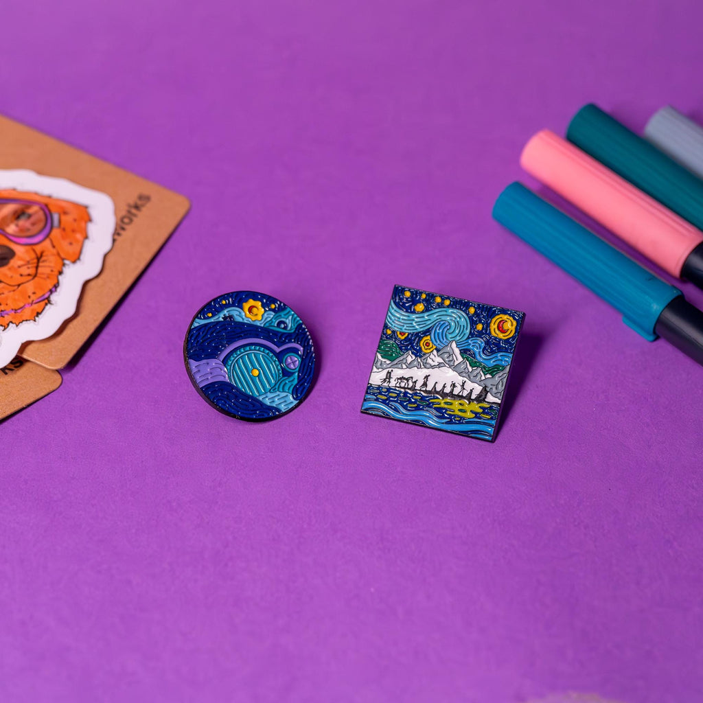 Two enamel pins inspired by Lord of the Rings, showcasing Starry Night-style art with the Fellowship and the iconic Hobbit’s door.