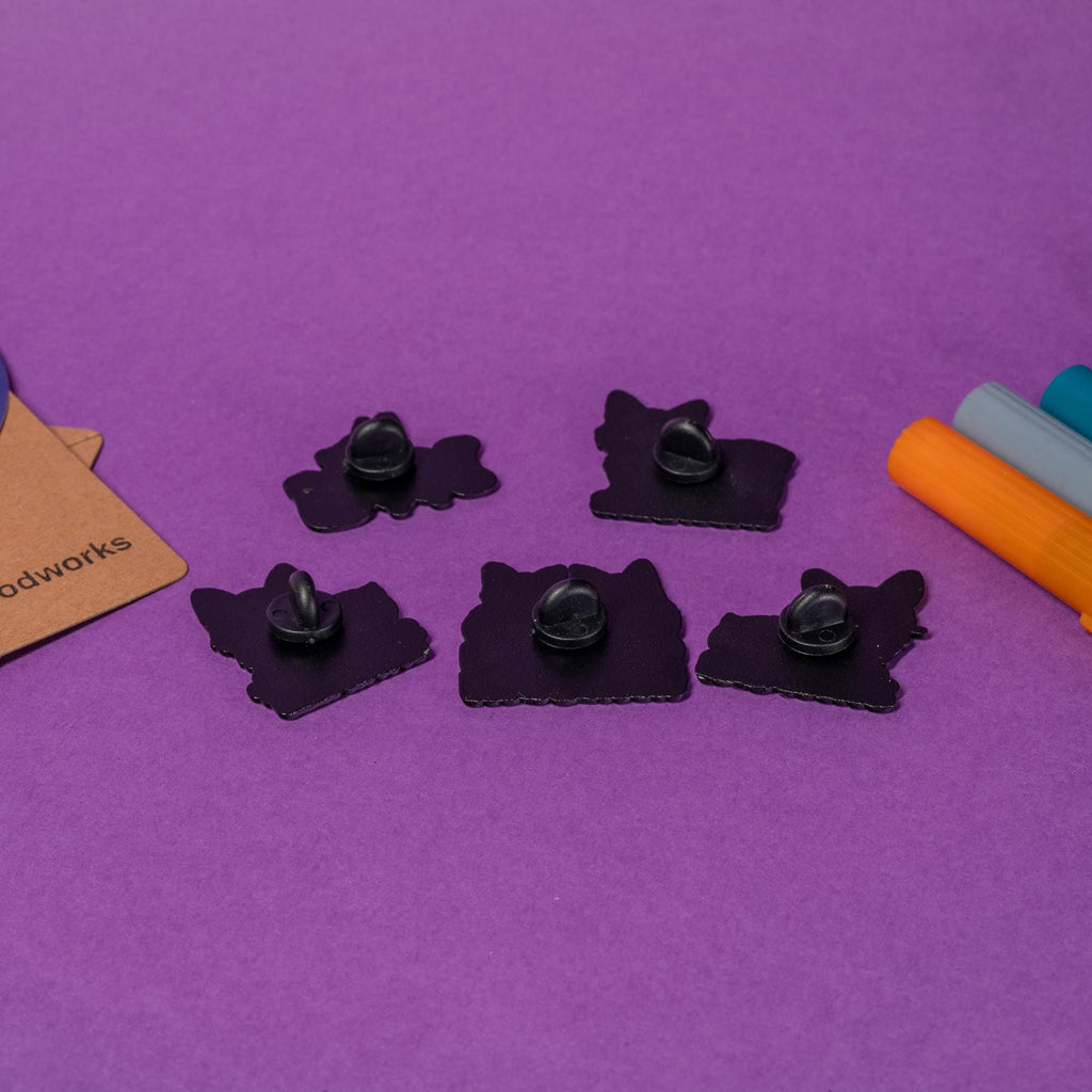 Group photo of 5 corgi enamel pins showcasing humorous and cute designs for corgi fans.