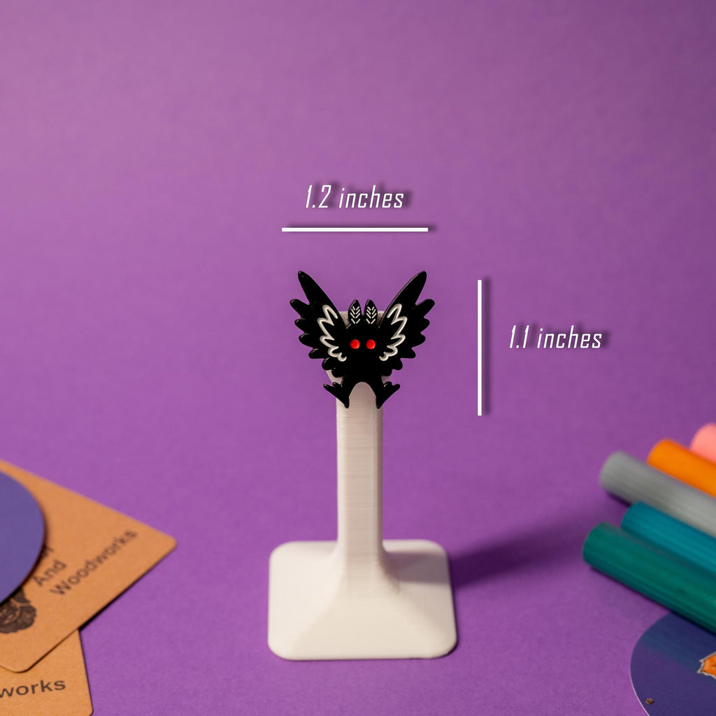 Close-up of Mothman enamel pin, showcasing its cryptid charm and unique craftsmanship.