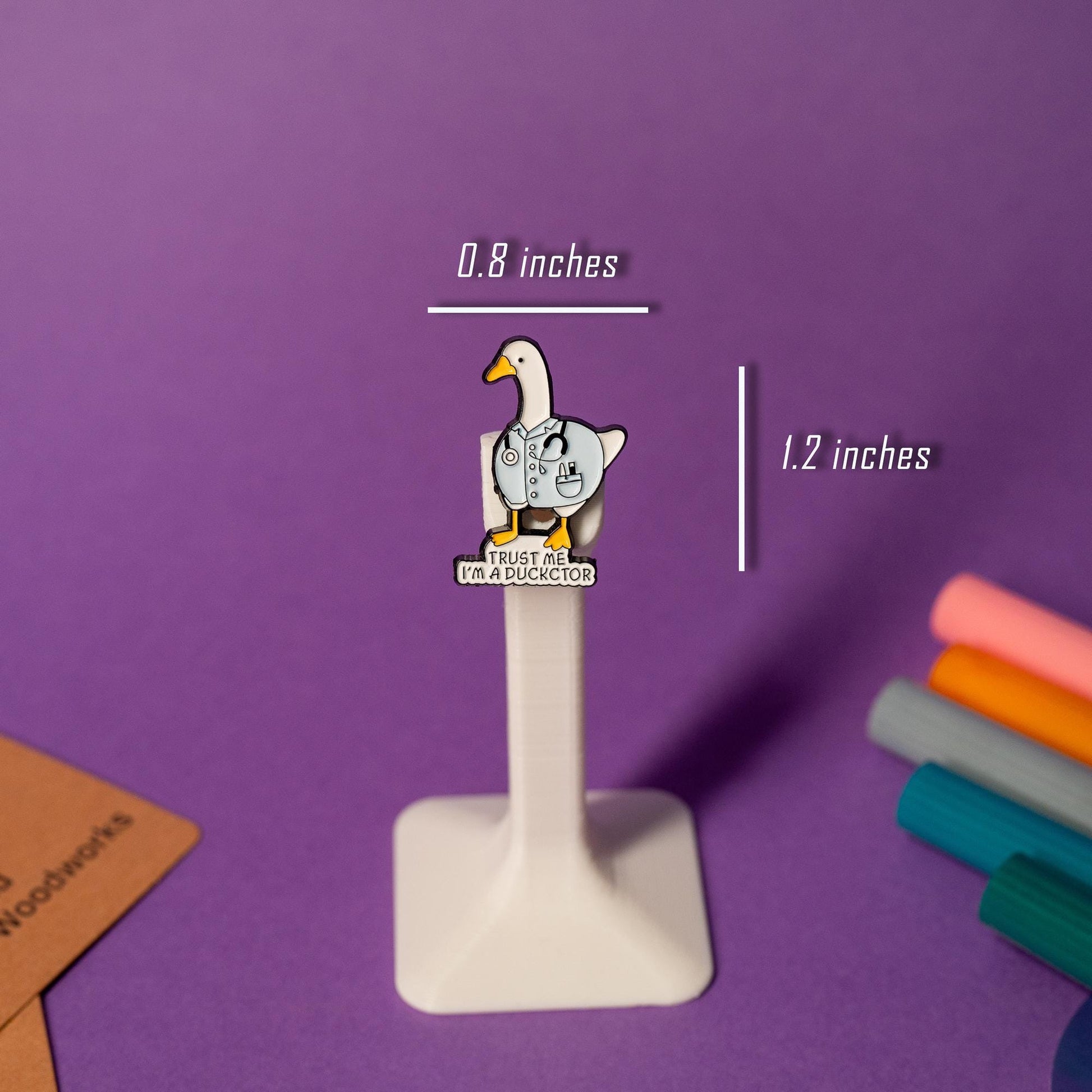 Duck enamel pin featuring a duck in a doctor’s coat with the text Trust me, I’m a Duckctor.