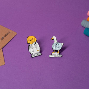 Set of funny doctor-themed enamel pins featuring a golden retriever and a duck, each with humorous text.