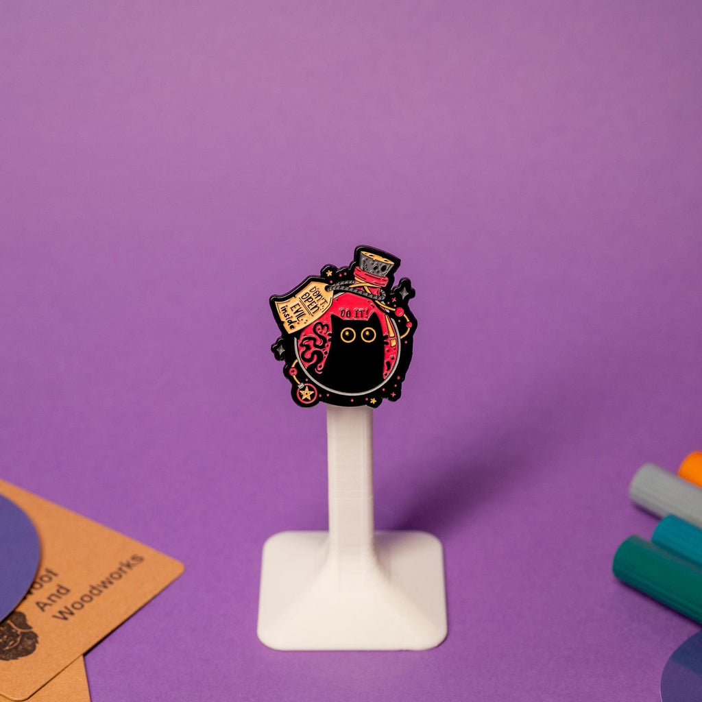 Enamel pin featuring a round-bottom flask with a black cat inside and the text Don’t Open – Evil Inside.