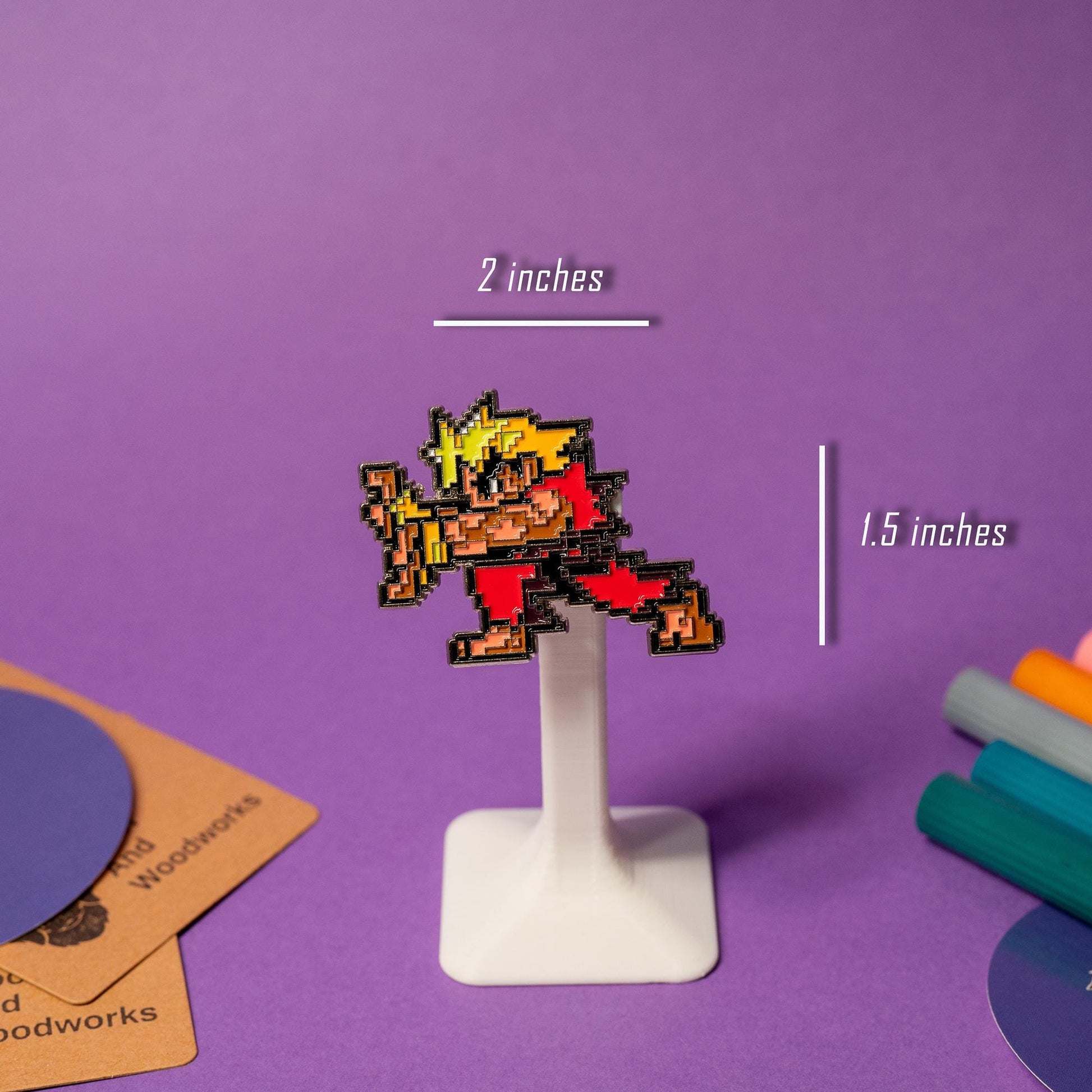 Close-up of pixel art enamel pin from the Street Fighter pin set, paired with his fireball pin.
