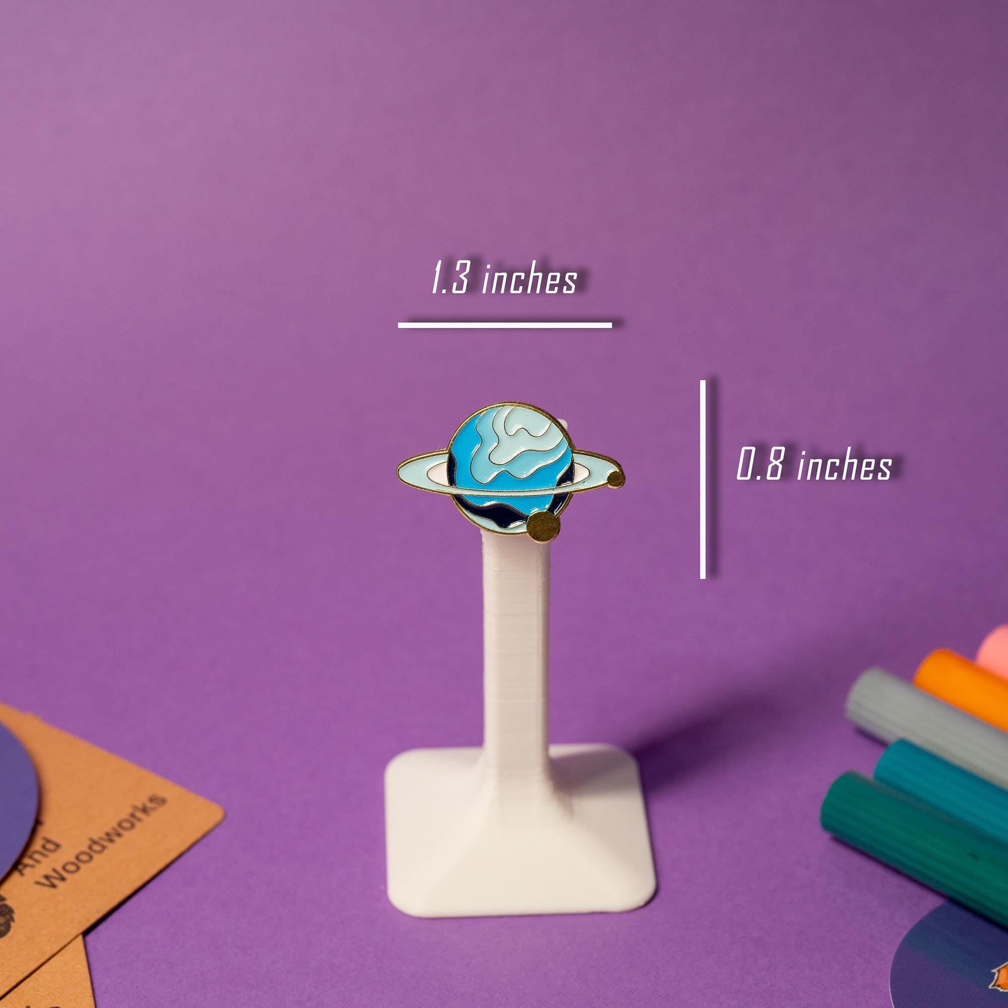 Close-up of a single planet enamel pin from the fantasy galaxy-inspired set, showcasing vibrant colors.