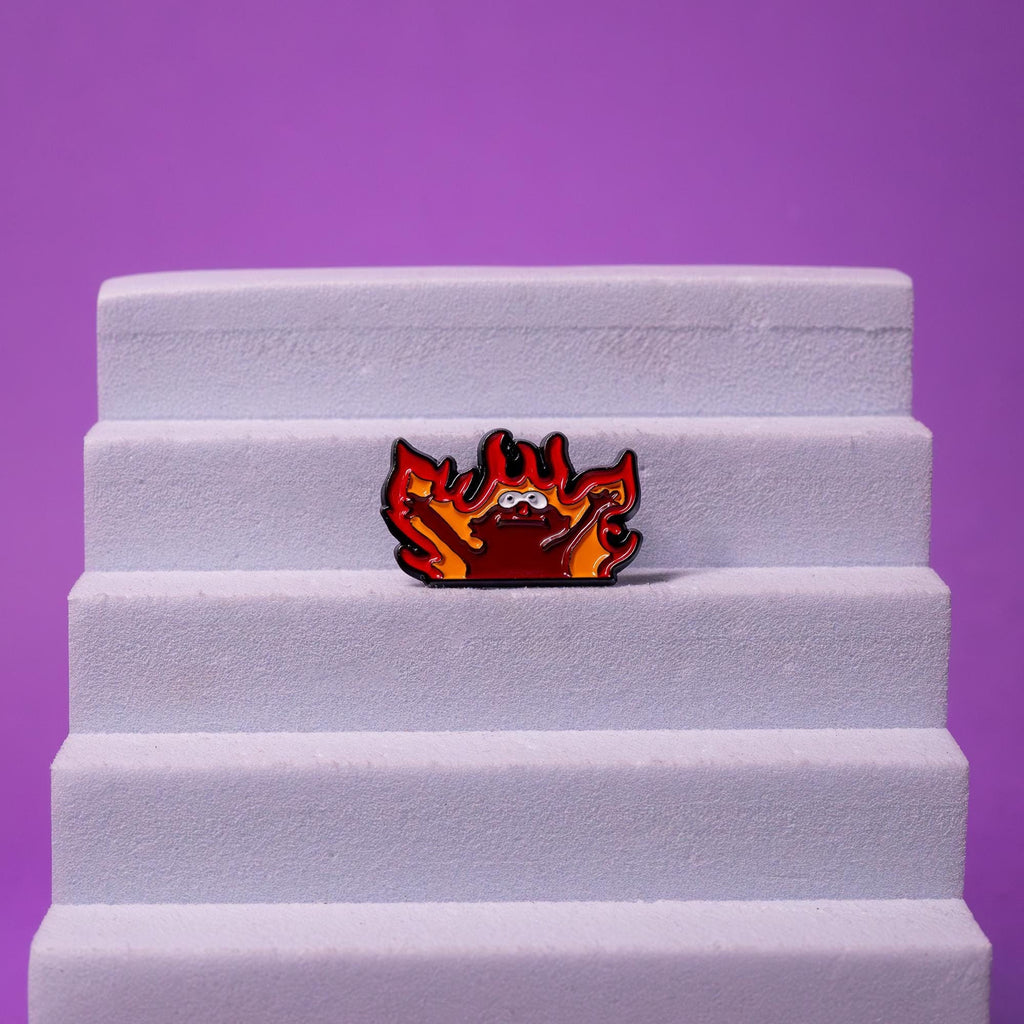 Hellmo enamel pin displayed on a foam stand, highlighting its vibrant colors and fun, meme-inspired design.