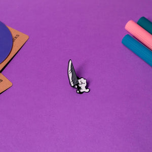 Front view of the Knife Cat enamel pin featuring a playful design of a mischievous cat holding a knife, perfect for cat lovers and humor enthusiasts.