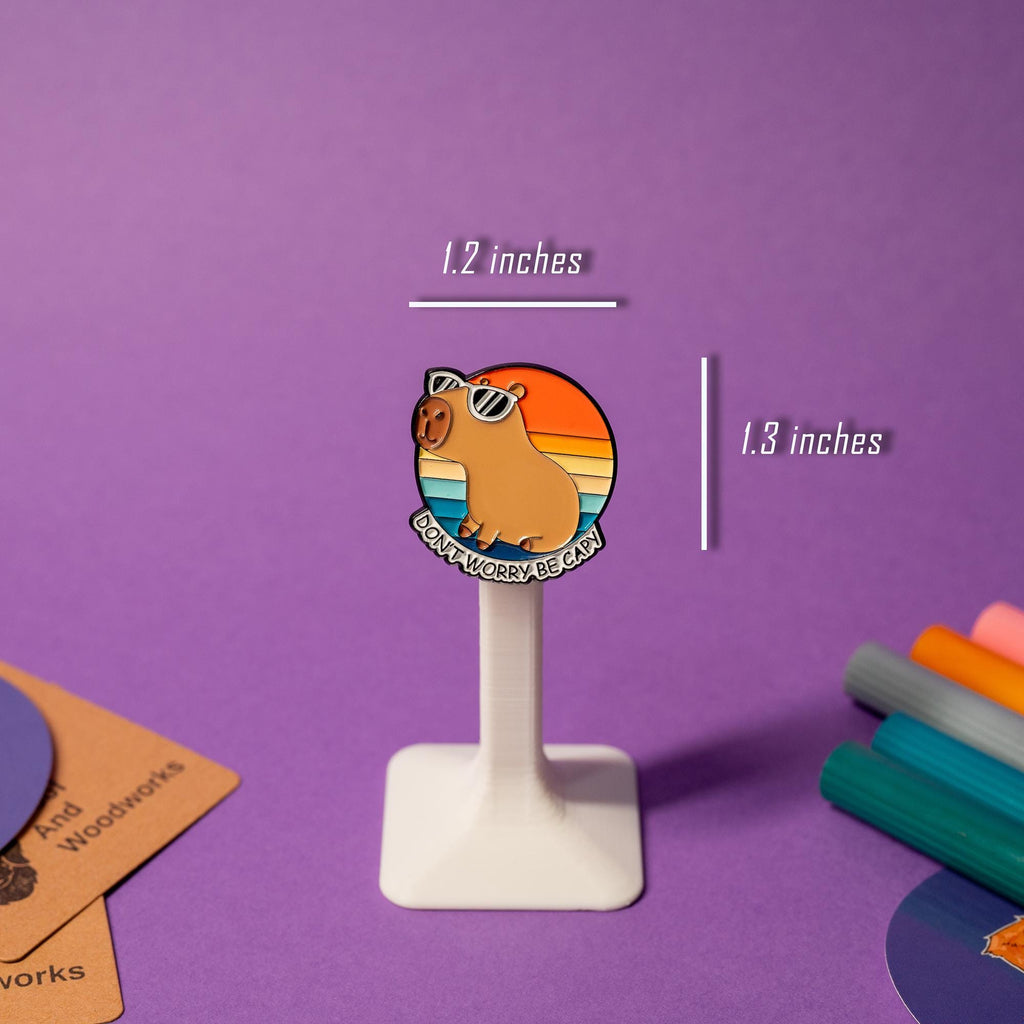 Enamel pin featuring a capybara in sunglasses with the text Don’t Worry Be Capy.