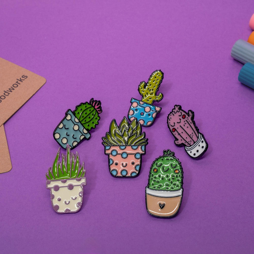 Set of 6 cactus enamel pins featuring adorable smiling faces and vibrant designs.
