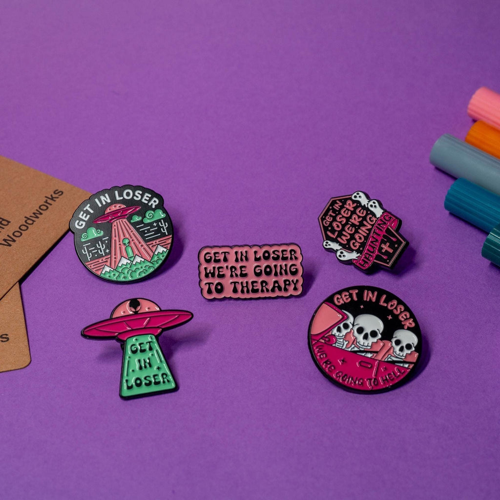 Complete collection of Get In Loser enamel pins, including alien abduction, spooky, and therapy themes.