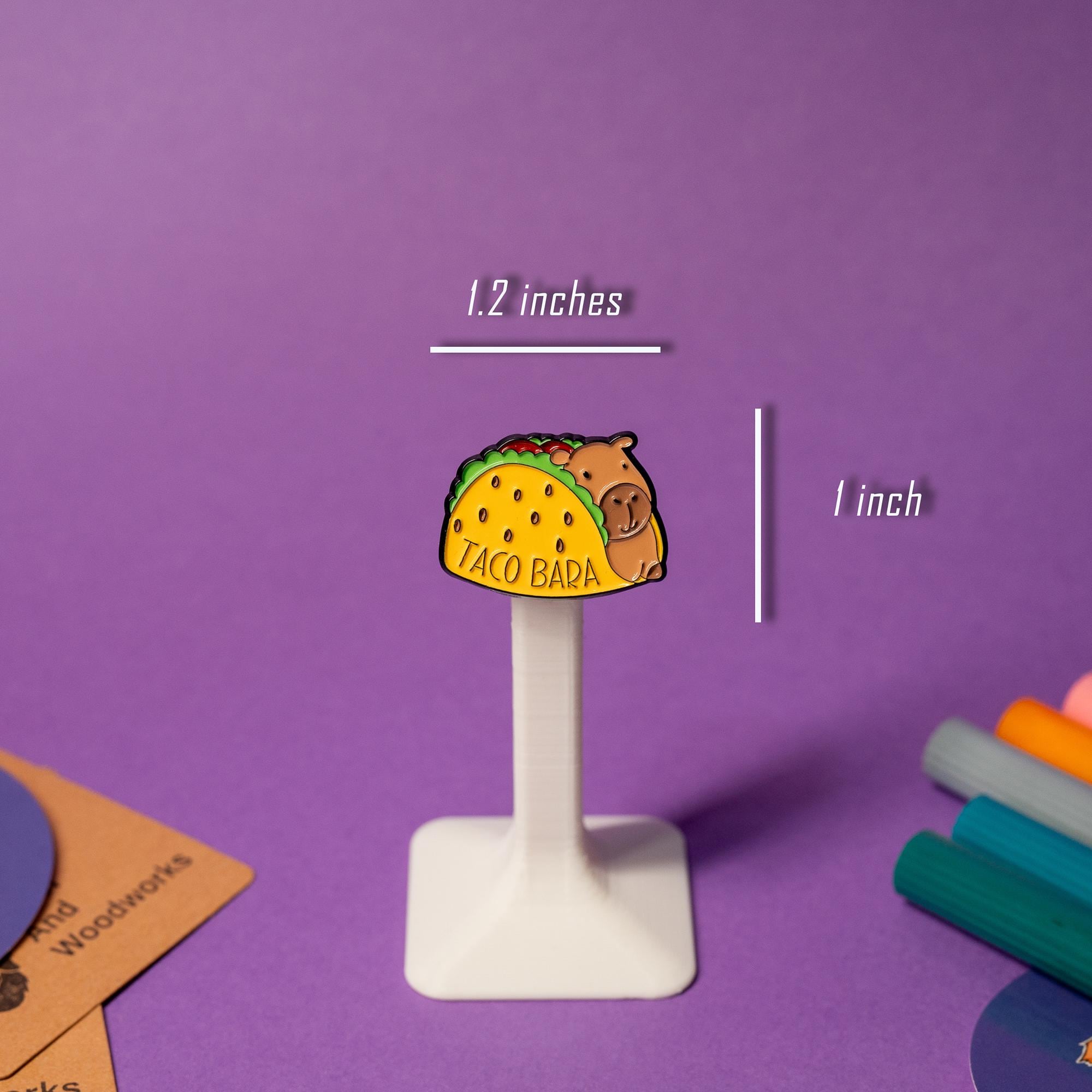 Close-up of the Taco Bara enamel pin, featuring a capybara holding a coffee cup.