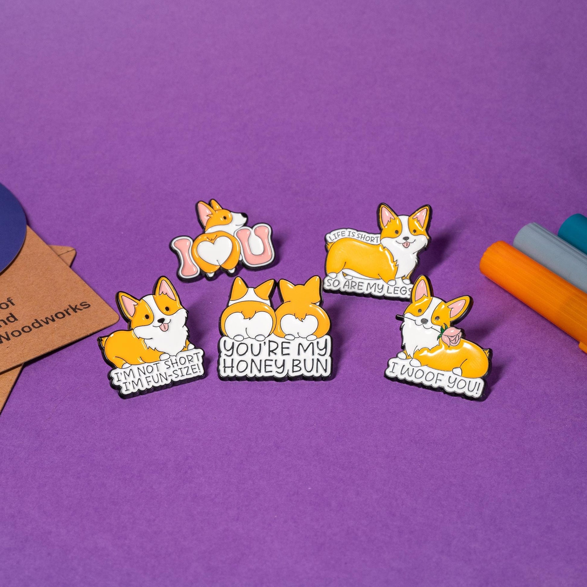 Set of 5 corgi enamel pins featuring funny and adorable designs: I Woof You, Life Is Short, Honey Bun, Fun-Size, and I Love U.