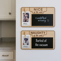 Two wooden "Nice of the Week" and "Naughty of the Week" dog behavior signs displayed on a stainless steel fridge in a modern kitchen setting.